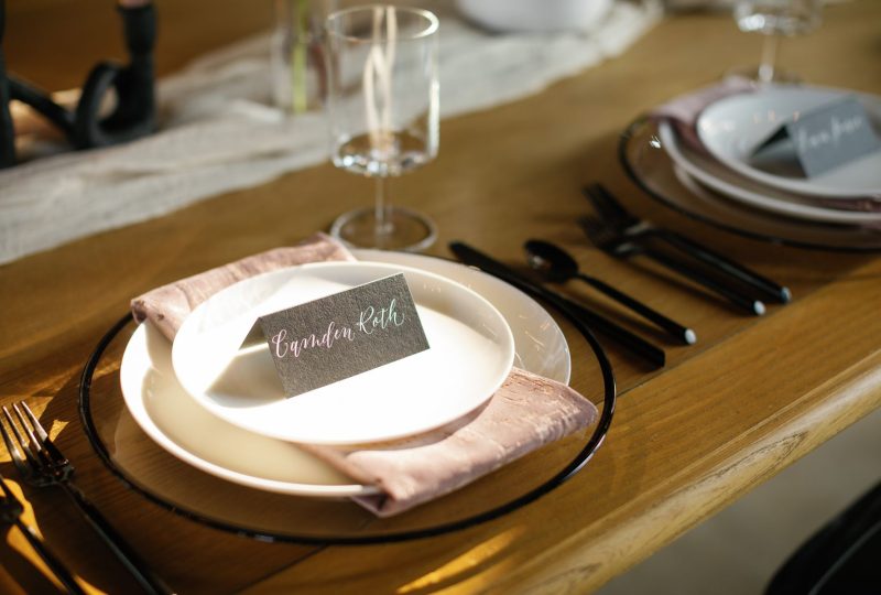 Towhee Club Editorial Shoot blush and black place setting on wood wedding reception table