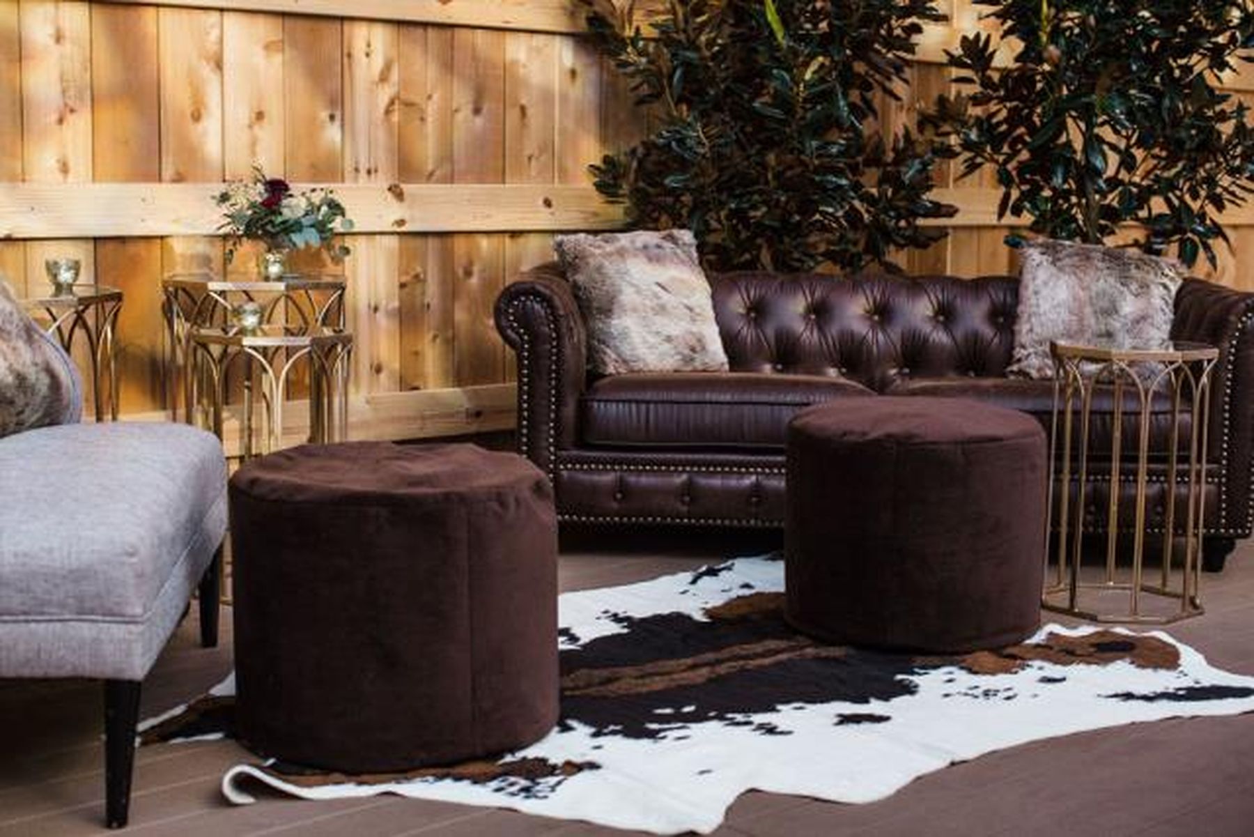 brown leather sofa and cowhide rug