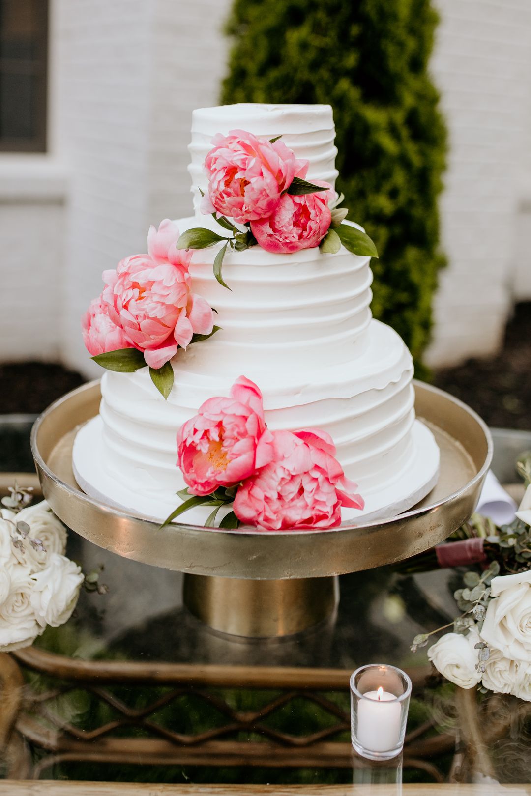 white wedding cake on gold stand