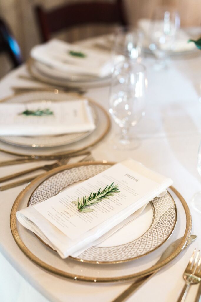 Wedding table arranged with golden cutlery and white charger plate. Mockup  for menu, invitation card, festive concept in vintage style Stock Photo