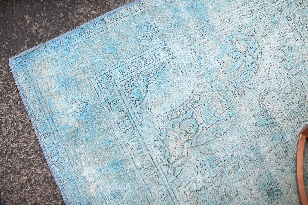 bright boho aqua rug for rent