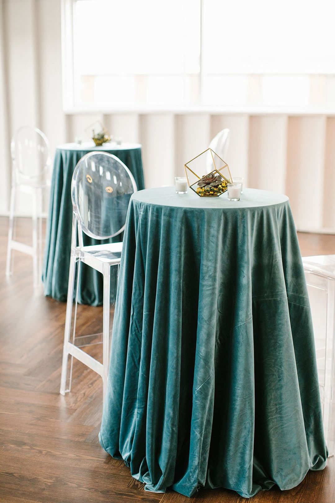 bistro table with blue linens, acrylic ghost barstool chairs