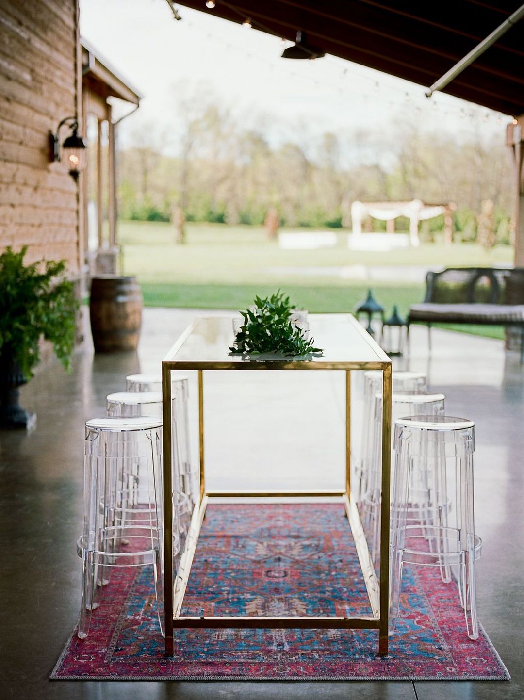 red and blue rug beneath cocktail hour bistro table