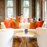 Ashleigh sofa and chairs with pink and orange pillows