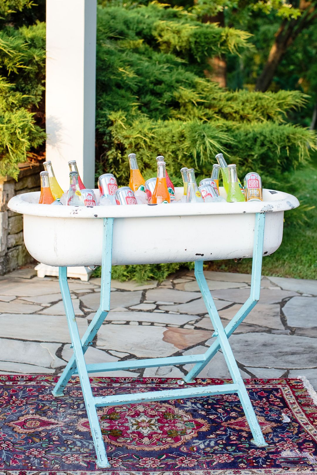 boutique festival event rentals - red-blue rug rental and vintage beverage tub