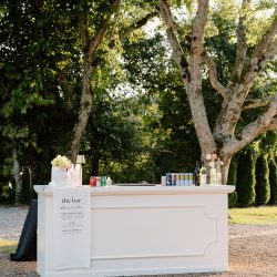 outdoor cocktail hour rentals; white wood event bar