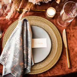 burnt orange and gold event table with burnt orange velvet table linens
